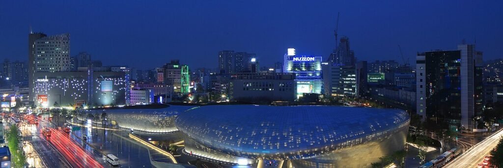 Zaha Hadid's Dongdaemun Design Plaza glowing at night in Seoul