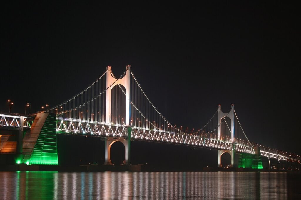 Gwangan Bridge illuminated at night over Gwangalli Beach, backdrop of the drone light show