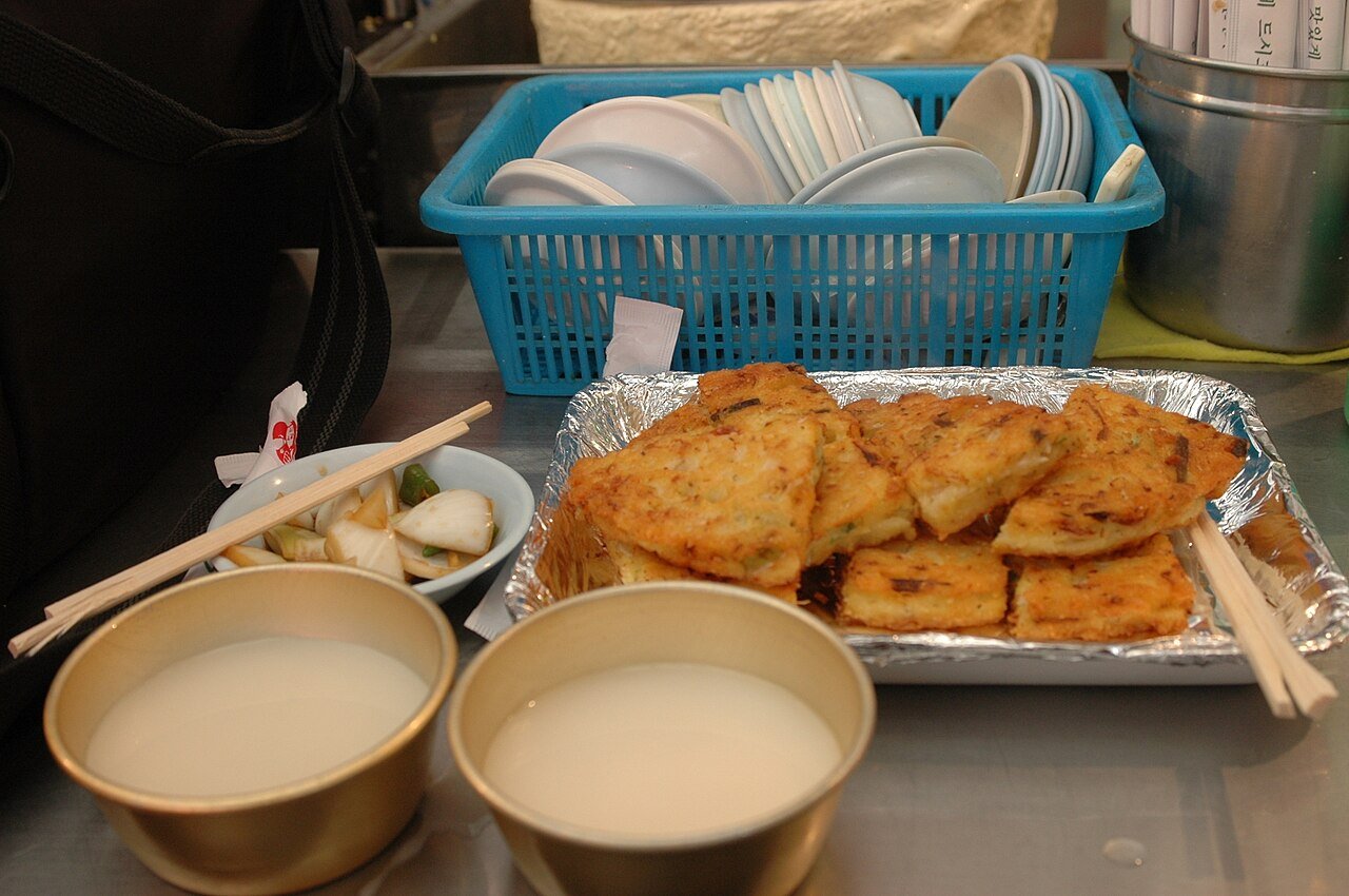 Crispy bindaetteok mung bean pancake served with makgeolli rice wine