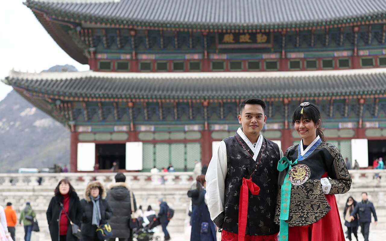 People wearing rented hanbok on the palace grounds at Gyeongbokgung
