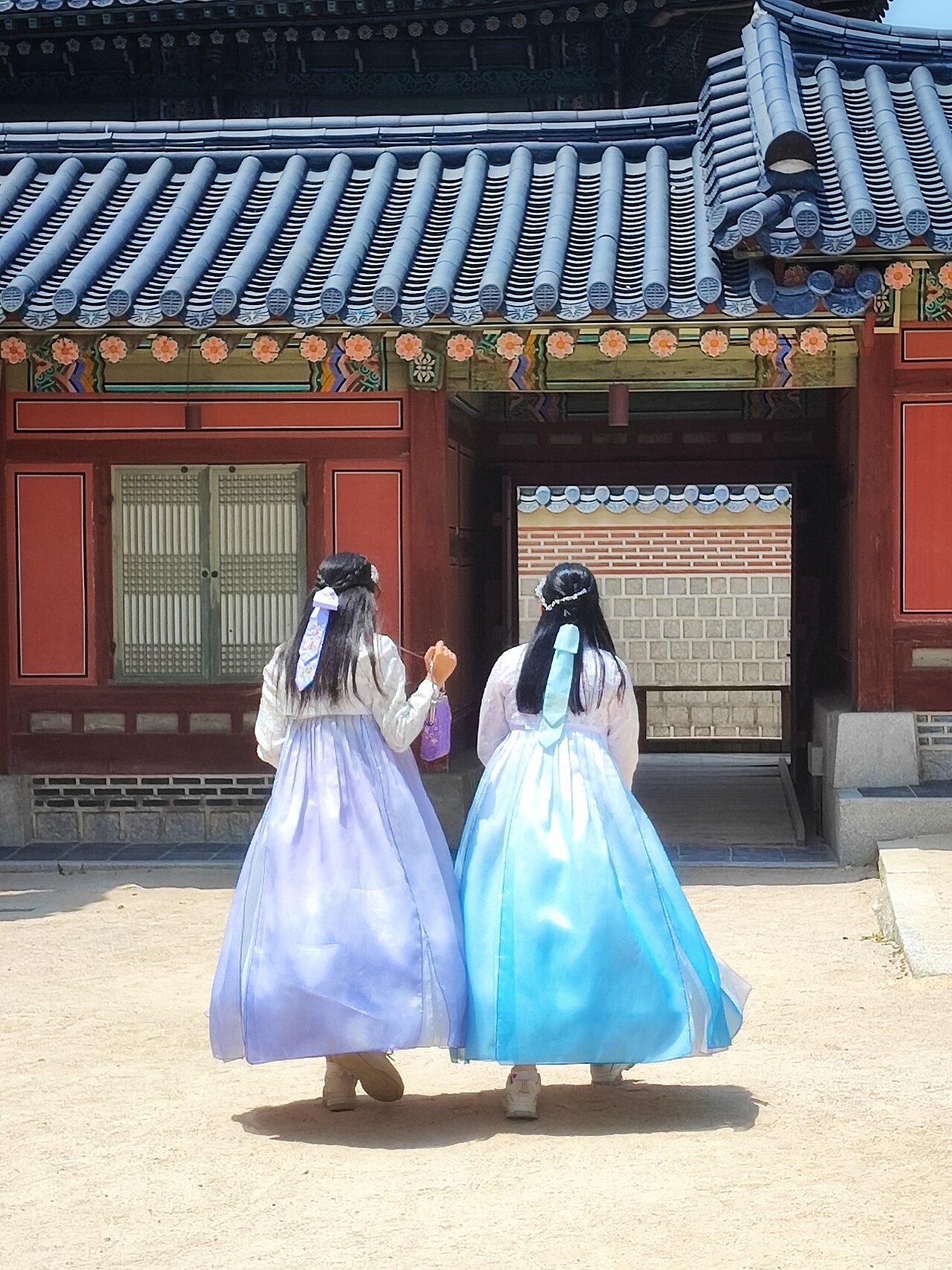 Visitors wearing rented hanbok at Gyeongbokgung Palace
