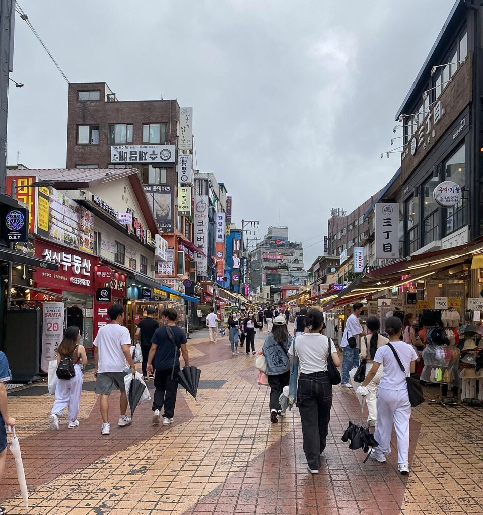 Busy Hongdae shopping street in Seoul lined with fashion and beauty stores