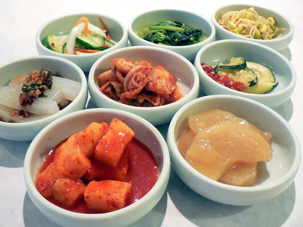Table crowded with banchan, the Korean side dishes that come with every meal