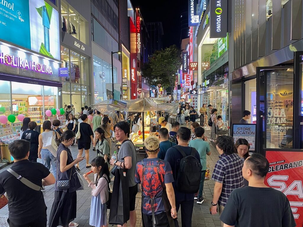 Myeongdong night market street food stalls lit up after dark in Seoul