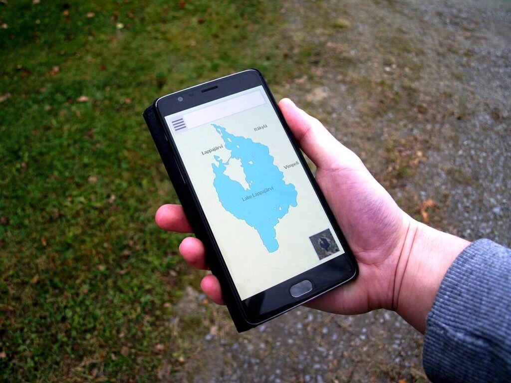 Hand holding a smartphone running a navigation map app