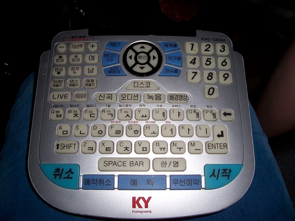 A private karaoke room with couches and a screen, like a Korean noraebang
