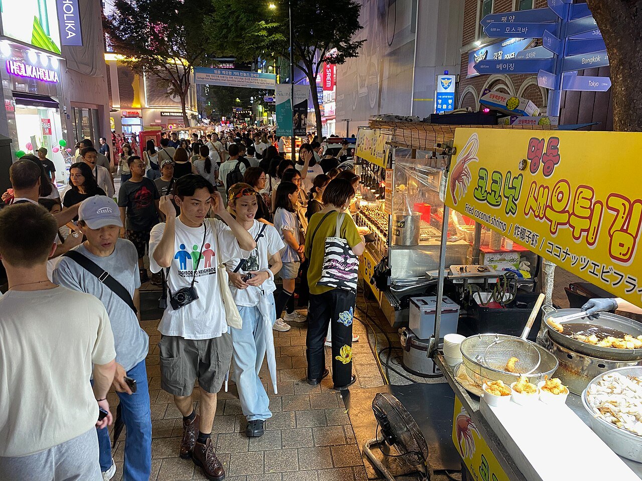 Myeongdong shopping street at night with cosmetics shops and market stalls