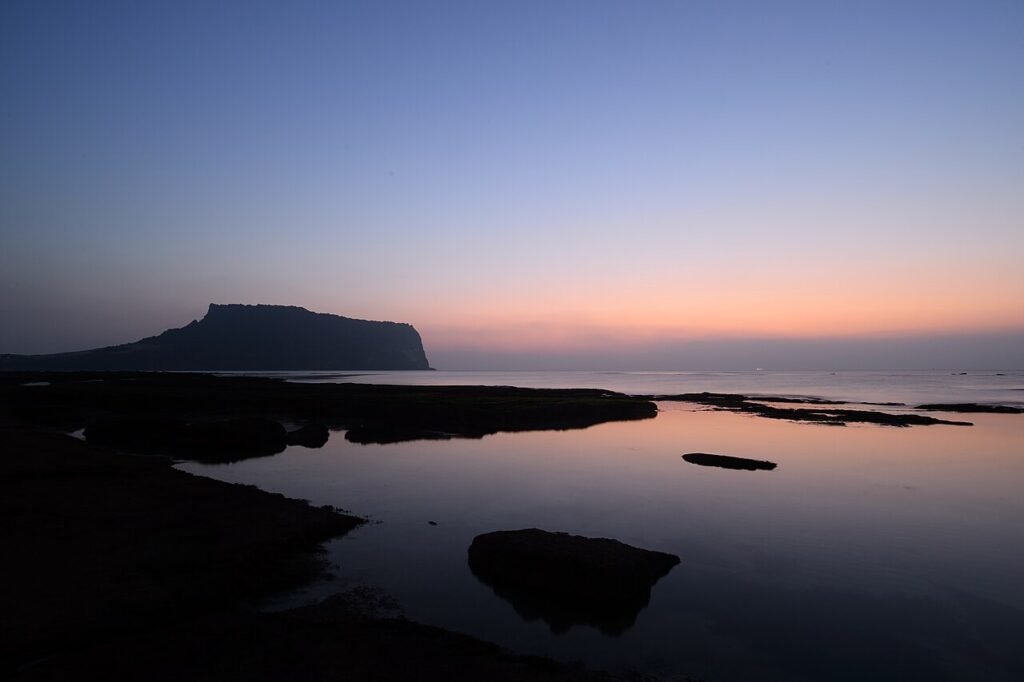 Sunrise glowing over the volcanic crater of Seongsan Ilchulbong on Jeju Island
