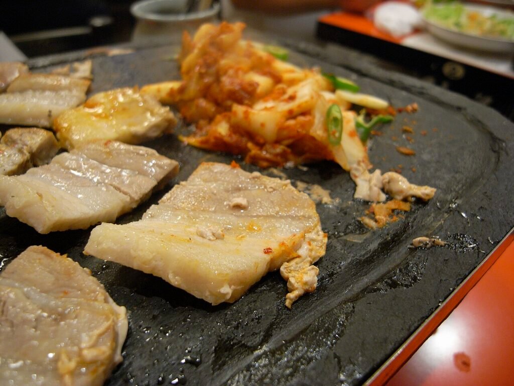 Korean charcoal barbecue grilling pork belly at the table