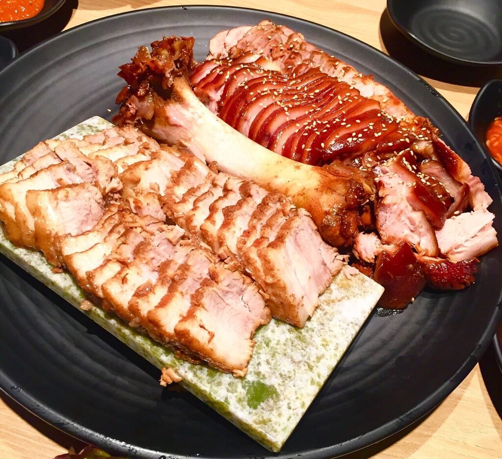 Bossam boiled pork slices and jokbal, ready for wrapping Korean-style
