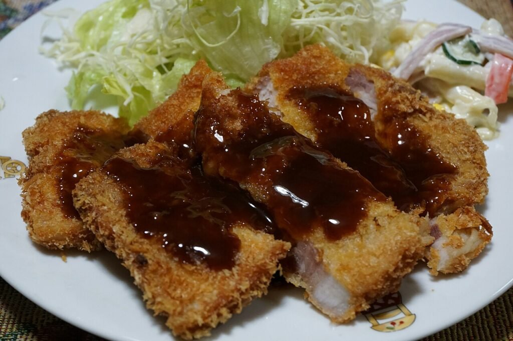 Crispy Korean-style pork cutlet (donkatsu) served on a plate