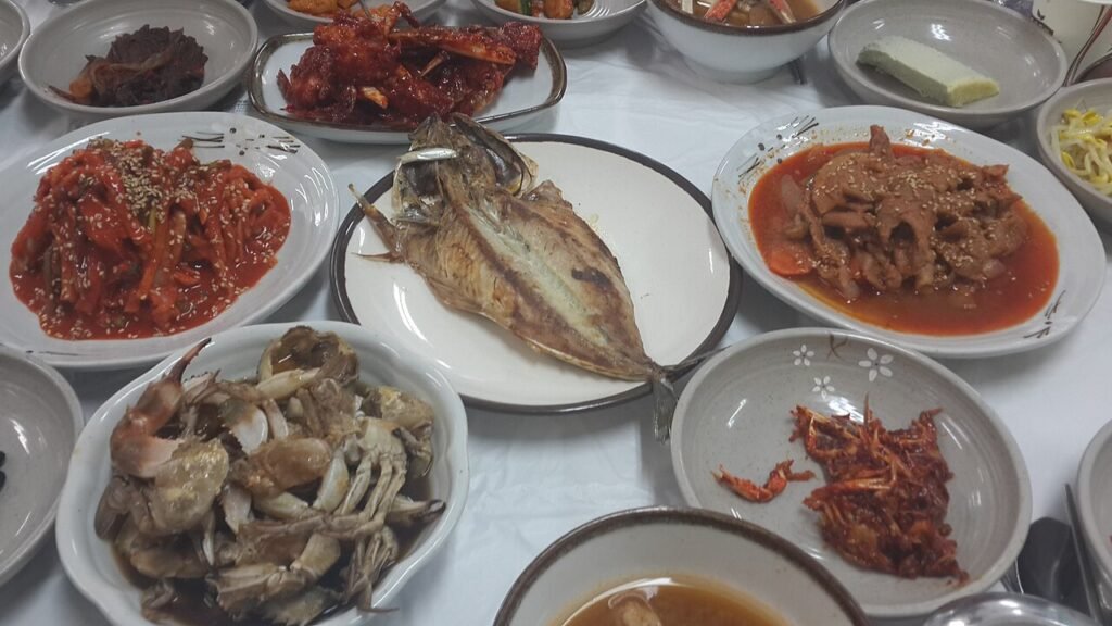 Korean grilled fish meal served with an array of banchan side dishes