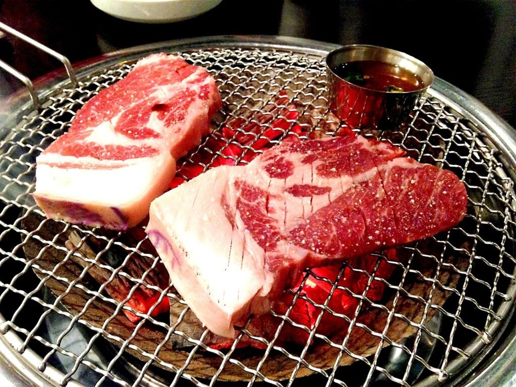Korean barbecue pork grilling over charcoal at the table