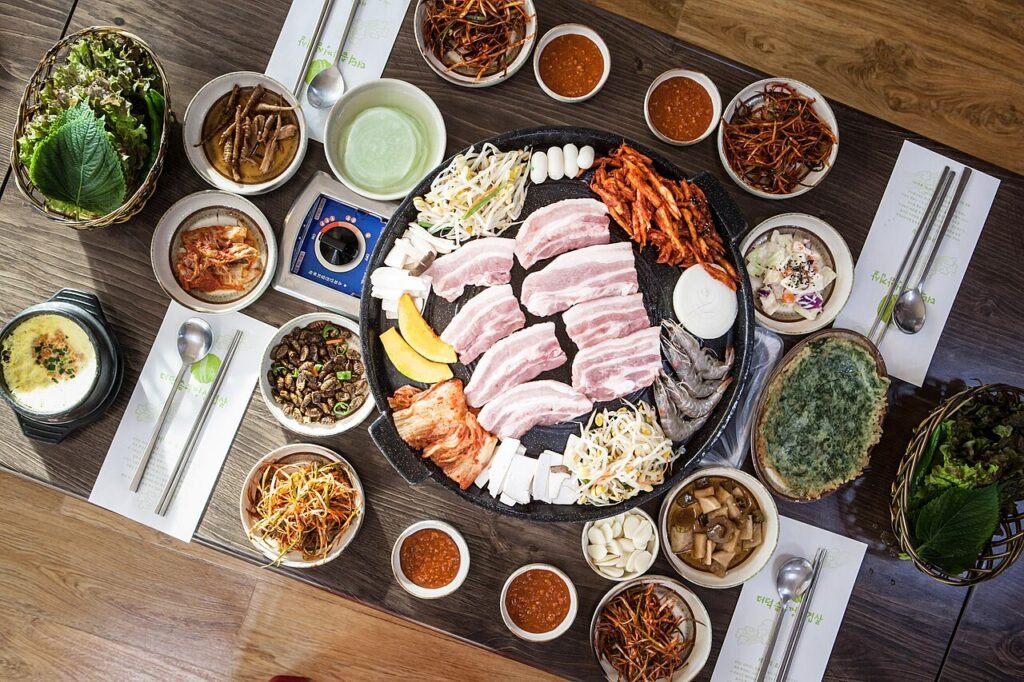 Grilled Korean pork belly (samgyeopsal) sizzling on a tabletop grill
