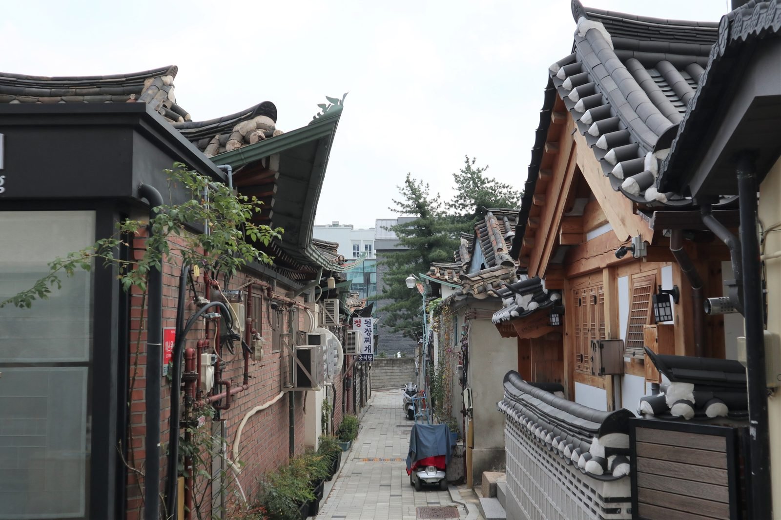 Hanok rooftops along a sloping lane in Bukchon Hanok Village, Seoul