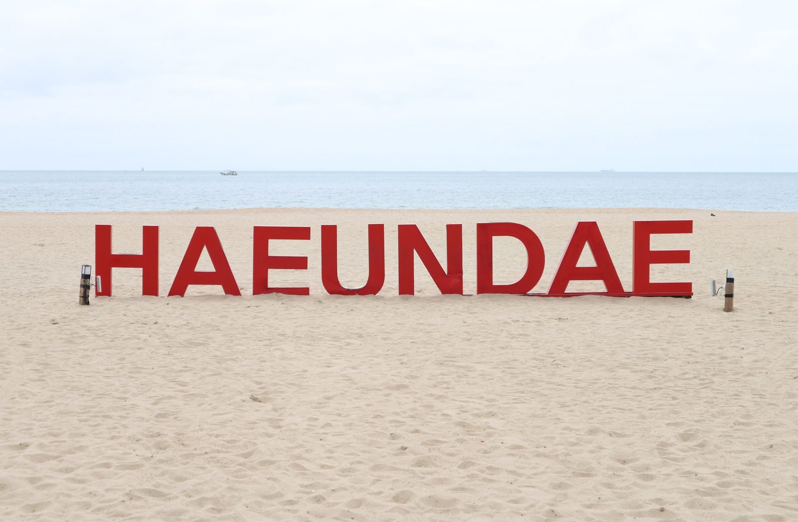 Haeundae Beach's wide crescent of sand with Busan's high-rise towers behind it