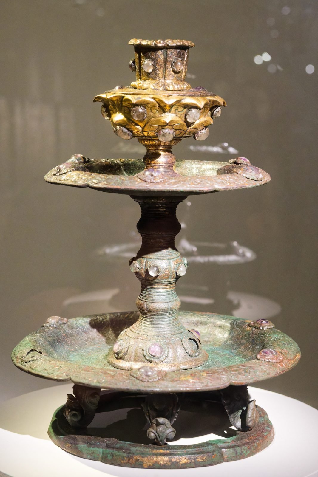 Ornate gilded bronze candlestick set with stones, a piece of early Korean metalwork